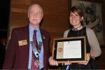 Club President Sarah Field receives the Charter from District Governor Laurie Cunningham